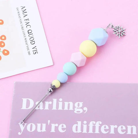 Premium Color Coded Scriber Needle For Sugar Craft And Cake Decorating Icing Pin with colorful beads and steel needle on pink background.