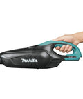 Hand holding 18V LXT Cordless Vacuum for Workshop and Home, ergonomic design with push button controls, tool only view.