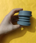 Heavy Duty Coffee Grinder Air Blow Bellow Compatible With Single Dose Hoppers Quick Press Cleanup Tool shown in hand against yellow background.