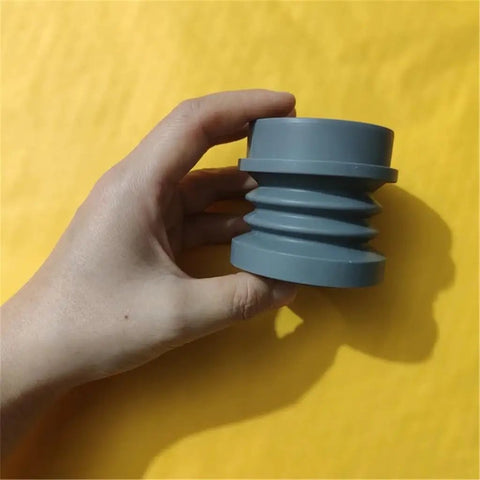 Heavy Duty Coffee Grinder Air Blow Bellow Compatible With Single Dose Hoppers Quick Press Cleanup Tool shown in hand against yellow background.