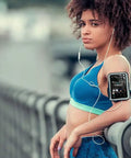 Woman using 72GB MP3 Player With Bluetooth And 4.0 Inch Full Touchscreen attached to her arm while exercising outdoors.