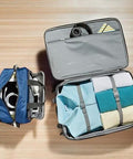 Open view of Amazon Basics navy blue luggage set: 23-inch expandable wheeled suitcase with clothes; 15-inch tote.