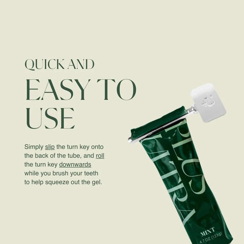 Toothpaste turn-key metal tube squeezer shown with a green toothpaste tube and metal roller lever