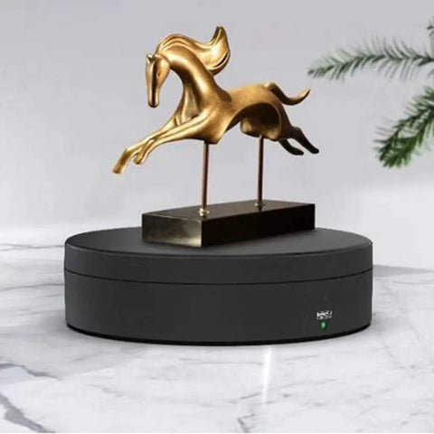 Luxury Electric Rotating Jewelry Display Stand With Mirrored Base, Smooth Spin Turntable For Rings, Necklaces & Watches on a black surface.
