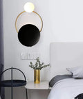 Fresh Modern LED Wall Sconce With Sturdy Iron Body, circular black and gold design, ambient lighting for bedrooms.