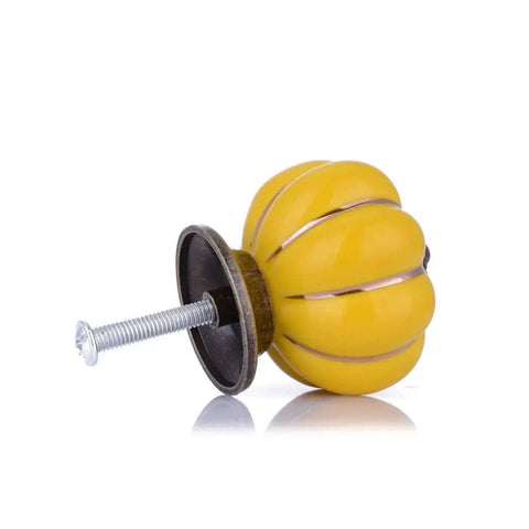 Smooth Yellow Ceramic Cabinet Knobs And Dresser Drawer Handles With Gold Alloy Trim Six Piece Set For Rad Kitchen Cabinet Makeovers And Dope Furniture Upgrades, side view of yellow knob with screw.