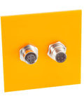 Bulkhead M12 D Code 4 Pin Male To Female Connector IP67 Shielded Wall Pass Thru Panel Mount Socket displayed on yellow panel