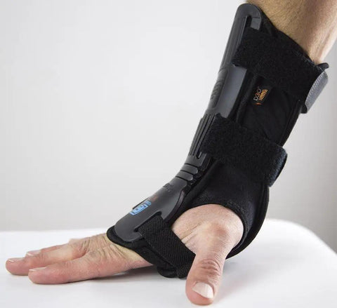 Flexmeter Double Sided Wrist Guards With Integrated D3O Impact Technology shown on hand, medium size, black with skid plates.