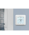 No Sweat Wiring Z Wave Plus Programmable Touchscreen Thermostat Featuring Smartstart Automation And Slick Low Voltage Hookup For Heat Pump And Conventional Homes In Crisp White mounted on interior wall.