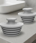 CONGARTENO Silicone Bathtub Drain Plug 2 Pack Gray Universal for 1.5-2 in. displayed on a countertop.