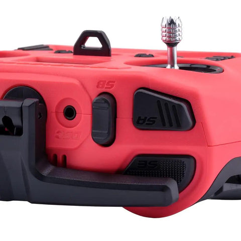 Close-up of Pocket Crush 2.4GHz ELRS Hall Gimbal Transmitter Remote Control, cherry red casing, black controls, compact antenna.