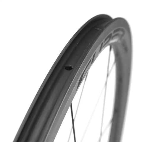 Close-up of 50/25mm UD Matte Finish Carbon Wheelset for 700c tubeless ready black road bike with V brake compatibility.