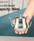 Mini 360Ml Stainless Steel Teapot For Tea And More, Ultra Compact Yet Sturdy Kitchen Pot For Coffee Olive Oil And Everyday Use, Easy Pour Design, Sleek Modern Look, Tiny But Mighty in hand against a blue background, highlighting size and design.