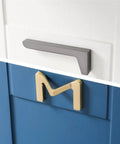 Dope Brushed Gold Cabinet Handles 64mm Drawer Pulls For Wardrobes And Furniture shown on a blue drawer.