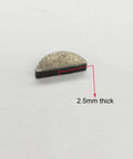Close-up of a single 2.5mm thick woodruff key from Moon Key Woodruff Key Set Of 20 For 2 Stroke 48cc 66cc 80cc Gas Motorized Bicycle Engines.