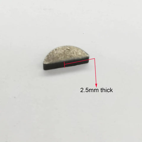 Close-up of a single 2.5mm thick woodruff key from Moon Key Woodruff Key Set Of 20 For 2 Stroke 48cc 66cc 80cc Gas Motorized Bicycle Engines.