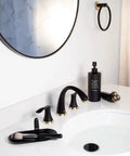 Black And Gold 8 Inch Widespread Bathroom Faucet With 3 Holes And Two Handles Drain Assembly And 27.6 Inch Supply Lines Solid Brass Lead Free Ceramic Disc Cartridges Easy Install Vanity Sink Tap installed on white countertop