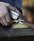 Person using 14 In 1 Mini Multitool Lightweight With Folding Scissors And 9 Piece Bit Set Holder Belt Clip Included Compact Storm Style Multi Tool