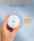 Hand holding a sleek wireless smoke detector, highlighting its ultra-compact design, 2.75 in diameter, 68% smaller than standard.