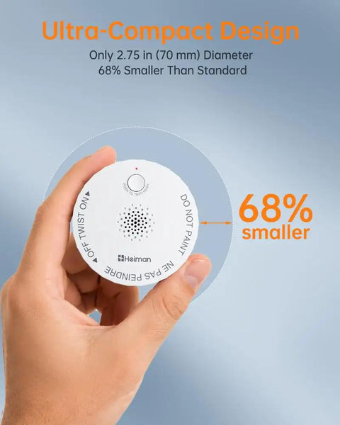Hand holding a sleek wireless smoke detector, highlighting its ultra-compact design, 2.75 in diameter, 68% smaller than standard.