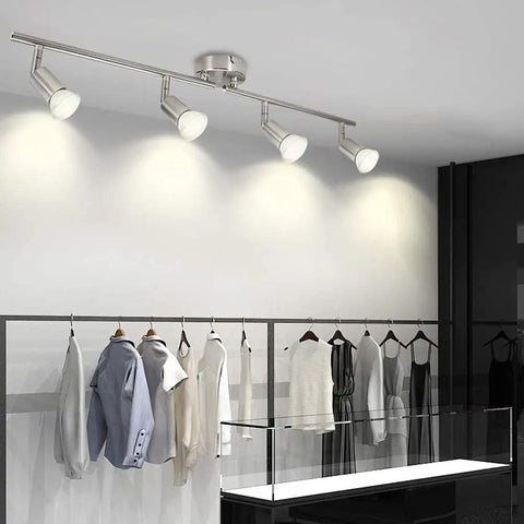 Sleek Modern LED 4-Light Track Lighting Kit With Flush Mount for wall or ceiling illuminating clothing in a modern retail space
