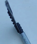 Close-up of reinforced spine on curved metal scythe blade with a 53 inch handle 22 and a half inch long blade by 2 and a quarter inch wide.
