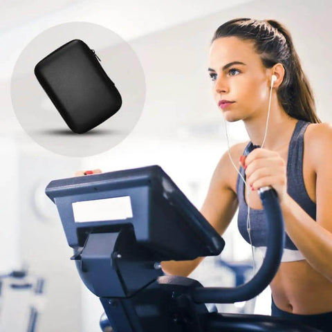 Badass Rugged Hard Drive Case For Portable SSD And HDD Universal Storage Organizer Pouch shown on exercise bike.