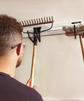 Person organizing tools on VersaTrack Garage Storage Rail With Twenty Piece Mounting Accessories For Drywall Studs And Masonry Pegboard