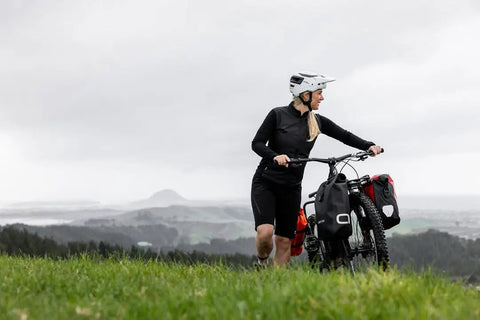 Cyclist with bike on hill using Spider Front Rack And Pannier Receiver For MTB And EMTB, Quick Release Front Cargo System