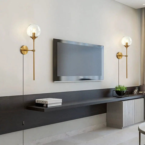 Room with Slick Modern Long Globe Plug In Wall Sconce Lights Set Of 2 With Clear Glass Globes Brass Gold Finish