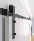 Black Straight Design Sliding Barn Door Hardware Kit for Single Wood Door, track system with roller installed on wall.