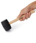 Hand holding All Purpose Rubber Mallet With Tent Peg Remover Hook, Double Sided High Impact Head, 16 Oz Hammer For Camping