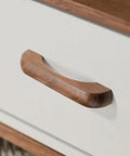 Close-up of a walnut wood drawer pull on a white cabinet, part of the Walnut Wood Drawer Pulls 6 Pack 3.78 Inch 96 mm Cabinet Handles.