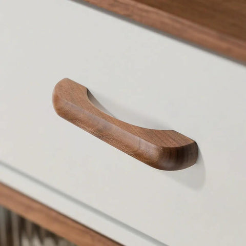 Close-up of a walnut wood drawer pull on a white cabinet, part of the Walnut Wood Drawer Pulls 6 Pack 3.78 Inch 96 mm Cabinet Handles.