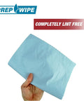 Hand holding blue sheet labeled 'Completely Lint Free', focusing on Heavy Duty Lint Free Cleaning Towels For Auto Body And Industrial Prep.
