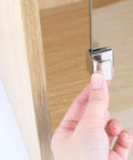 Zinc Alloy Cabinet Hinge Assembly With Integrated Soft Close Damper shown being attached to a cabinet door.