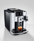 Level Up Your Daily Grind With This Sleek Chrome Automatic Coffee Machine Boasting One Touch Operation Built In Grinder And Rich Foam Frother For A Real Deal Barista Experience Certified Refurbished, front angle with coffee glass.