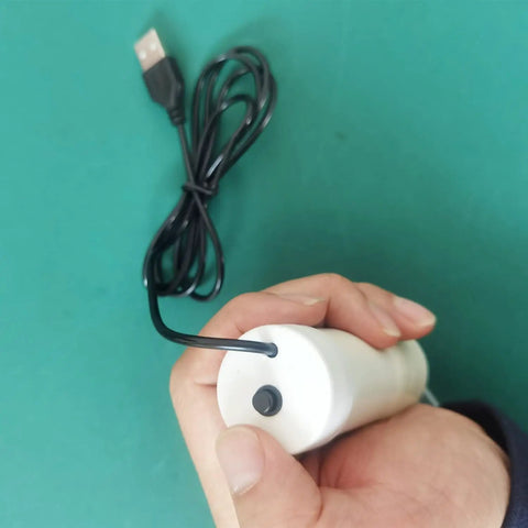 Hassle Free Grab And Go Portable Usb Oil Extractor Pump With Suction Syringe Flexible Hose held in hand for easy use.