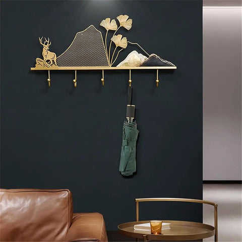 Tough Metal Wall Hook Heavy Duty Coat Rack With Extra Spacious Storage For Keys Umbrellas Coats And Hats on a black wall featuring a decorative nature design.
