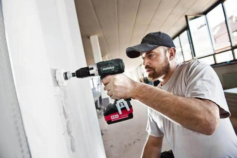 High Performance 18V Cordless Drill Driver With Brushless Motor And Dual 2Ah Lithium Ion Batteries Using One Half Inch Keyless Chuck For Heavy Duty Projects And Weekend Buildouts Built Like A Tank For True Pro Power in use drilling into drywall.