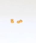 Gold Plated 5.8mm Textured Spacer Beads, Laser Cut Round Metal Rings For Bracelets And Jewelry Making, 1.8mm Hole, Sparkling Reflective Finish, Available In 10, 30, Or 50 Piece Sets shown in a small group on white
