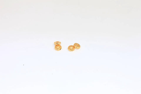 Gold Plated 5.8mm Textured Spacer Beads, Laser Cut Round Metal Rings For Bracelets And Jewelry Making, 1.8mm Hole, Sparkling Reflective Finish, Available In 10, 30, Or 50 Piece Sets shown in a small group on white