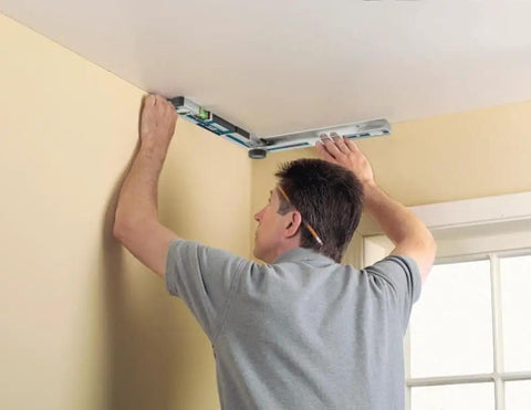 No Sweat Heavy Duty Digital Angle Finder Miter Calculator Protractor Level in use to measure a ceiling corner.