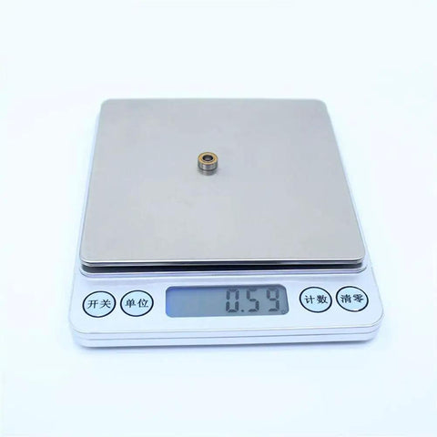 10 Pack MR84RS MR84-2RS Color Ball Bearings for Hobby RC Cars and Trucks on digital scale showing weight 0.59