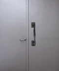 Old School Vintage Barn Door Handle for Sliding Doors and Gates, rustic metal gate pull on grey door, side view.