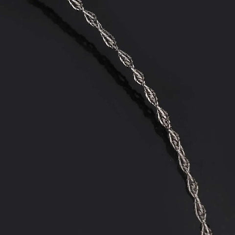 Close-up of the four-strand cable from the Beefy Stainless Steel Portable Wire Saw For Outdoor Wood Cutting, Survival And Camping Gear.