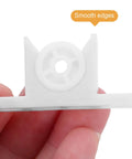 Close-up of white plastic piece from 30 Sets Plastic Ball Door Catch Hardware Kit For Cabinets And Closets With Screws Included Easy Install Durable Yet Silent Closure False Front Clips Perfect For DIY Cabinet Makeovers, held in hand showing smooth edges.