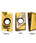 Three tin-coated APMT1604 carbide turning inserts with central hole, 9.24x16 mm, R0.8 radius.