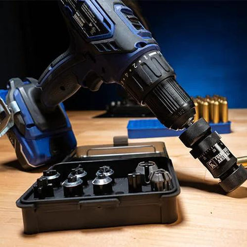 Front view of a cordless drill with a case-trimmer attachment in the chuck beside a black storage case of trimming heads