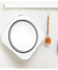 Road Trip Ready Lightweight Folding Wash Basin One Point Four Gallon Capacity No Fuss Bpa Free Plastic Soaking Tub For Dorm Life Camping Treks And Housework Tasks Matte Grey hanging on a hook.